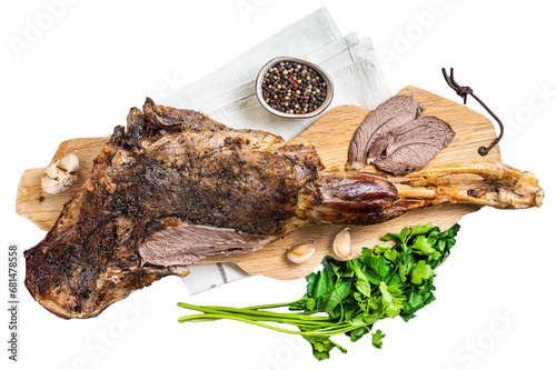 Whole roast mutton lamb leg with spices on a wooden board. Transparent background. Isolated.