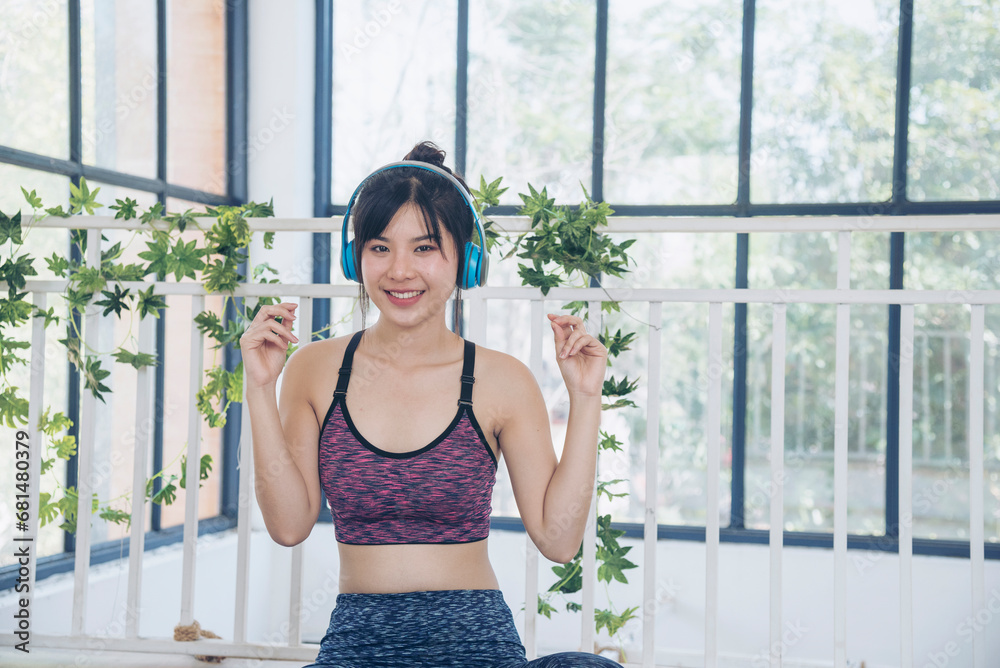 Yoga woman workout in sportswear sit on yoga mat home fitness workout exercise. Happy beauty women dance on floor use headphone listen to music wellness lifestyle. Beautiful woman smile listen music Yoga woman workout in sportswear sit on yoga mat home fitness workout exercise. Happy beauty women dance on floor use headphone listen to music wellness lifestyle. Beautiful woman smile listen music