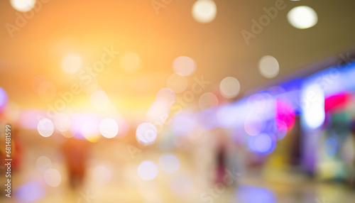 A blurred image of a shopping mall with colorful lights, abstract blur image background of shopping mall with light bokeh and flare light bulb