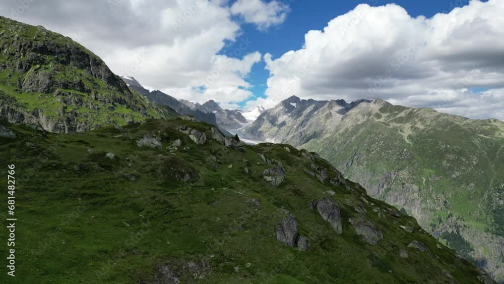 Witness the grandeur of the Aletsch Arena Glacier and the picturesque Swiss Alps in this aerial video. The drone captures the stunning landscapes, revealing the beauty and serenity of the Swiss mounta