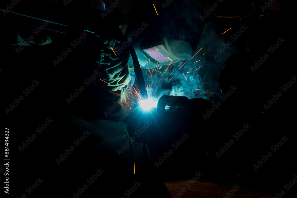 sparks while welder uses torch to welding