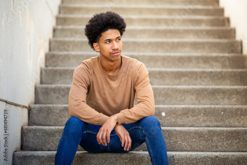 cool young african american man sitting on stairs