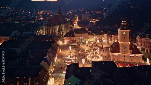 Aerial hyper-lapse view of European Christmas Market old town, with huge decorated Christmas tree . Winter holidays and Christmas celebration concept in Europe photo