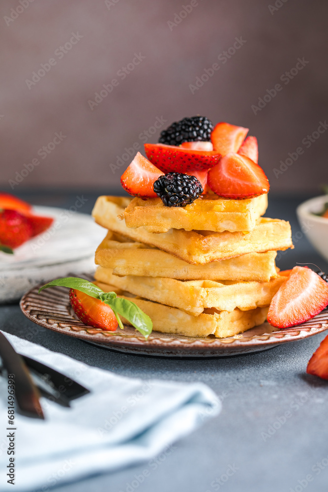 Waffles and Strawberries stacked on a plate. Belgian homemade waffles Waffles and Strawberries stacked on a plate. Belgian homemade waffles