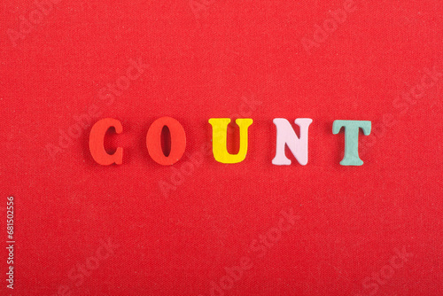COUNT word on red background composed from colorful abc alphabet block wooden letters, copy space for ad text. Learning english concept.