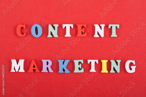 CONTENT MARKETING word on red background composed from colorful abc alphabet block wooden letters, copy space for ad text. Learning english concept.