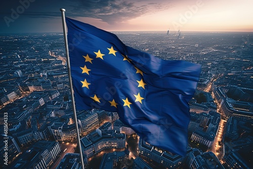 The developing flag of the European Union in the background of a European city and buildings photo