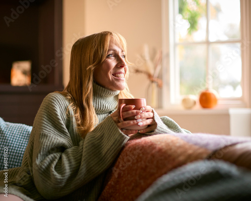 Photography Smiling Woman At Home Wearing Winter Jumper With Warming Hot Drink Of Tea Or Cof