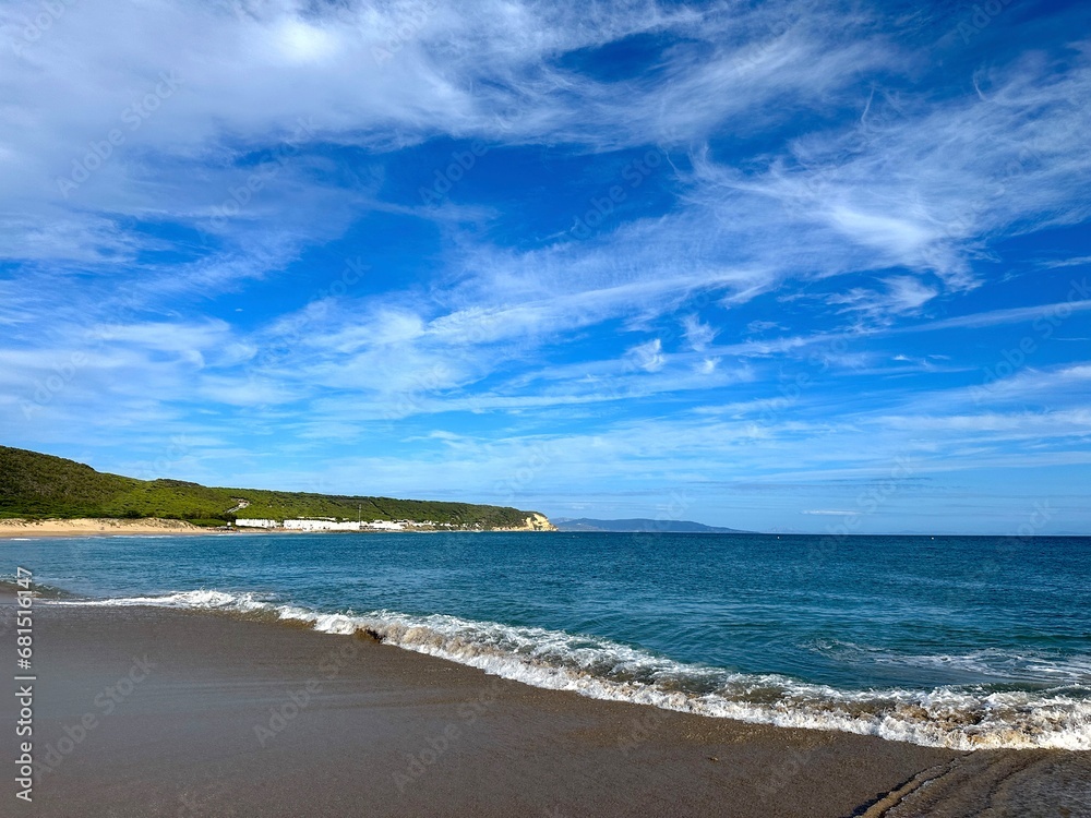 beach near Faro de Trafalgar with a view over Cala del Varadero towards cliffs and mountains behind the bay of the Atlantic, Zahora, Conil de la Frontera, Vejer de la Frontera, Costa de la Luz, Spain