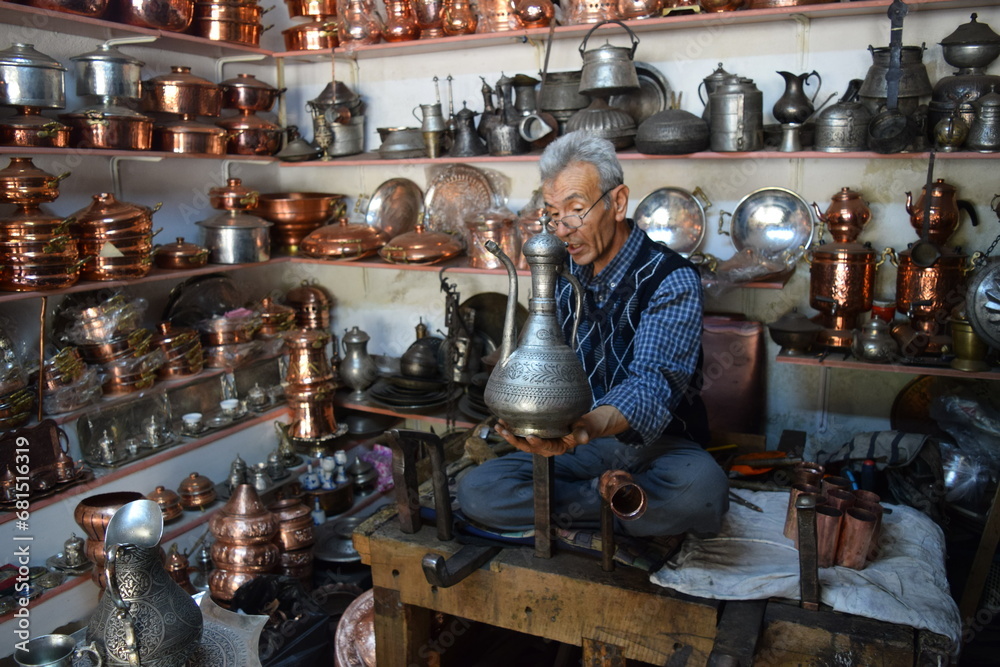 A tinsmith, in his, tinsmith's shop,The master, of working, with copper, in his shop A tinsmith, in his, tinsmith's shop,The master, of working, with copper, in his shop