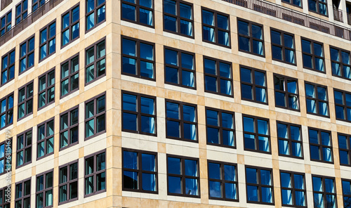 Pattern of square windows, made of squares, on a square modern building. Quadrangle shape of contemporary fenestra or casement show modern apartments or flats in Berlin, Germany. Real estate agency photo