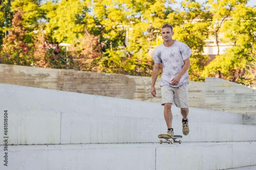 Fototapeta premium Man riding skateboard in skate park