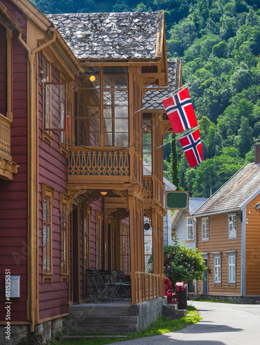 View of wooden house with Danish flags on porch photo