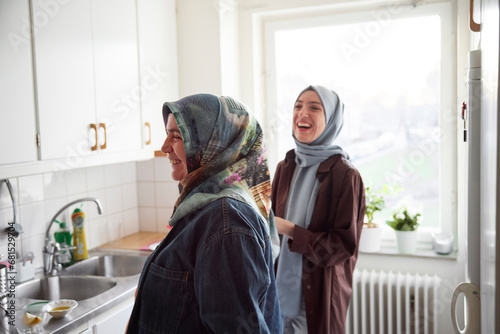 Women in headscarves cooking together for eid al-fitr at home photo