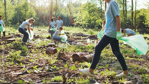 Multicultural people with a voluntary organization conserving environment. Enthusiastic eco activists of different ages collecting garbage, rubbish. Save the Earth and ecology pollution concept