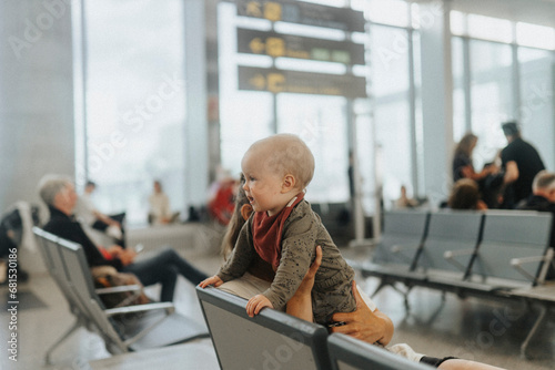 Mother with baby waiting at airport photo
