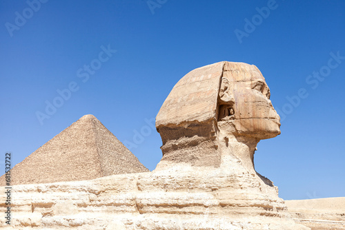 The Sphinx and Pyramid of Mycerinus against clear blue sky photo