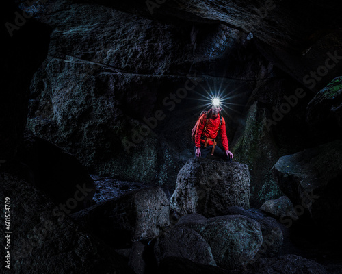 Man with headlamp exploring cave photo