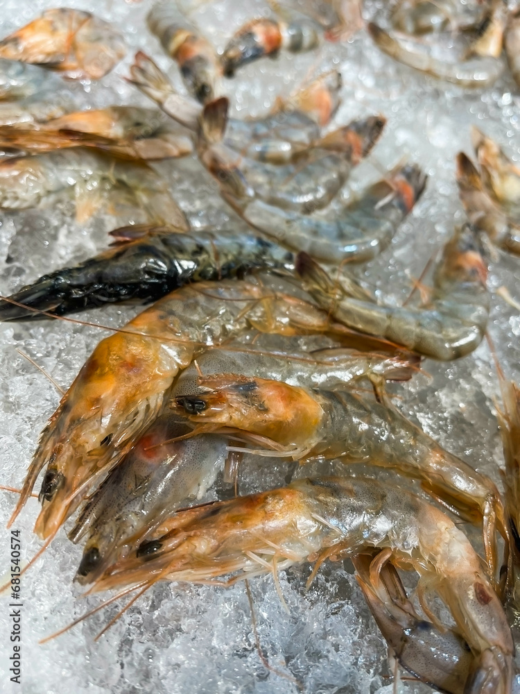 Lots of large chilled shrimp on ice Lots of large chilled shrimp on ice
