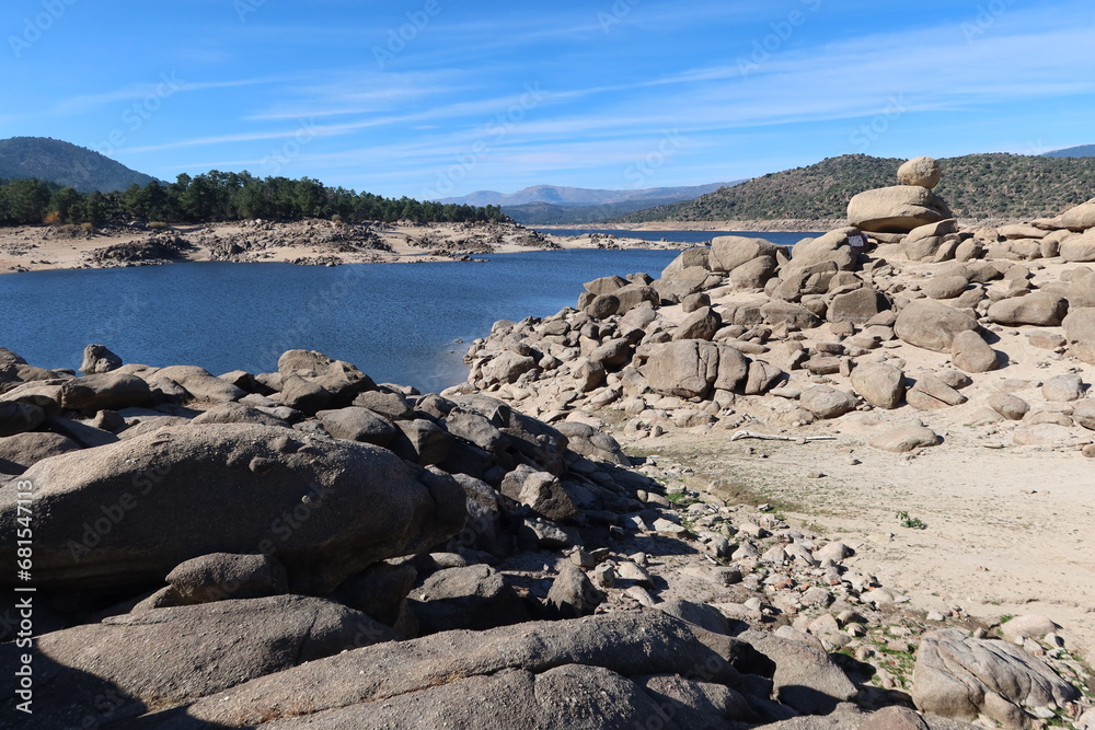El Burguillo Reservoir, Avila, Spain, November 13, 2023: View of the water and large stones in the El Burguillo Reservoir, Avila, Spain