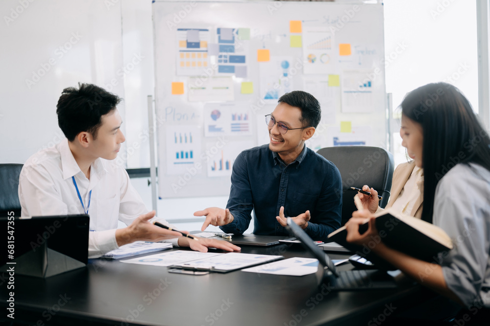 Happy businesspeople while collaborating on a new project in an office. Group of diverse businesspeople Happy businesspeople while collaborating on a new project in an office. Group of diverse businesspeople