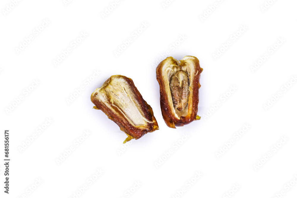 Close-up view of delicious golden Sukkari dates sliced in half showing the date flesh and seeds inside isolated on a white background. Ramadan Arabic food concept top view. Close-up view of delicious golden Sukkari dates sliced in half showing the date flesh and seeds inside isolated on a white background. Ramadan Arabic food concept top view.