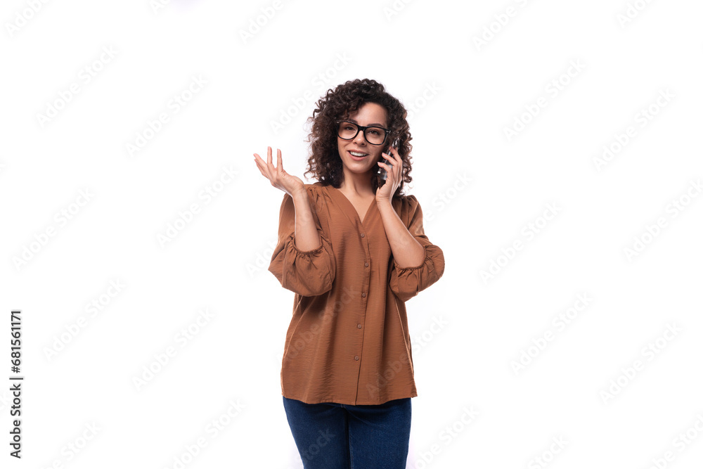 young slender brunette woman dressed in a brown shirt speaks on the phone young slender brunette woman dressed in a brown shirt speaks on the phone