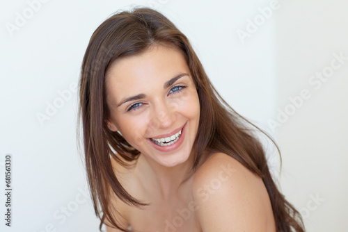 Portrait, smile and beauty with a woman laughing in studio on a white background for natural skincare. Face, aesthetic or funny and a happy person looking confident with her antiaging skin routine