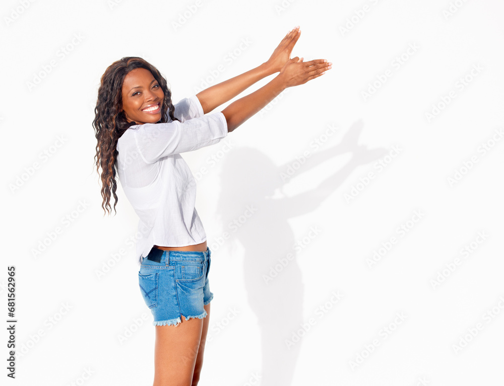 Obraz premium Bird shadow, black woman and portrait with hands in wings shape flying in a studio. Happy, smile and African female person with modern and casual fashion hand gesture for creative puppet show