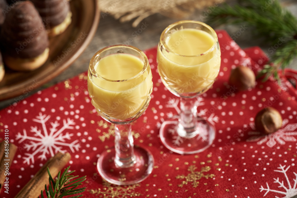Two glasses of eggnog with wasp nests - Czech Christmas cookies in the background Two glasses of eggnog with wasp nests - Czech Christmas cookies in the background