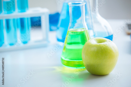 Green Apple in food science lab for high antioxidant bio flavonoid vitamin C nutrition healthcare extraction from fruit. photo