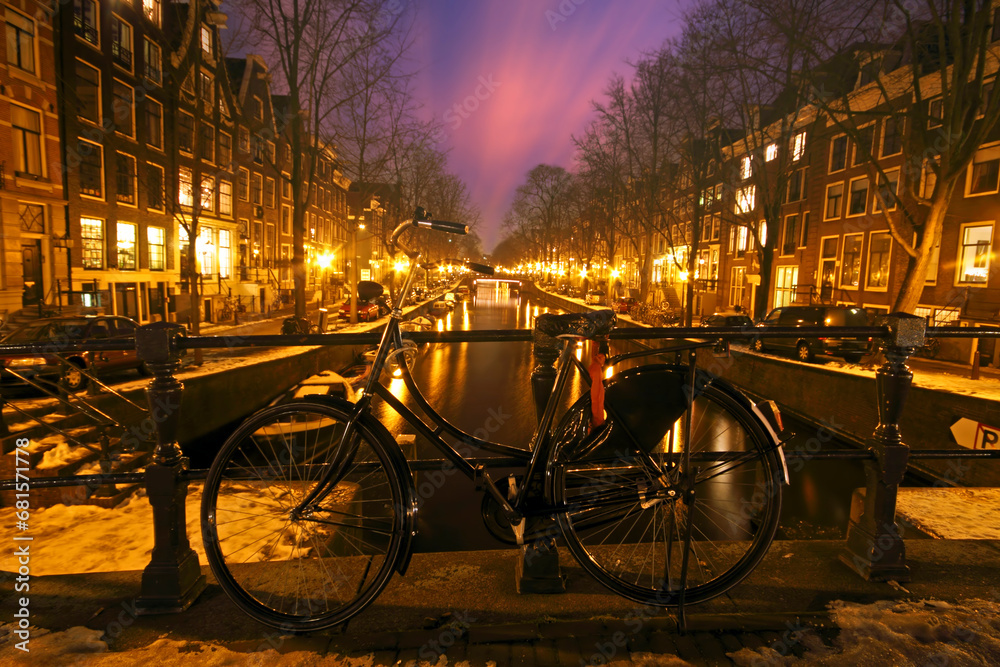 Bicycle against a bridge in Amsterdam the Netherlands at night