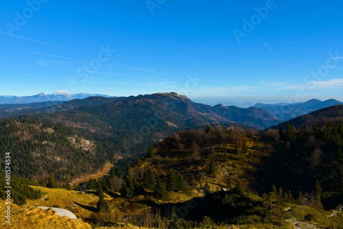 View of Ratitovec mountain range above forest covered Jelovica plateau in Gorenjska, Slovenia