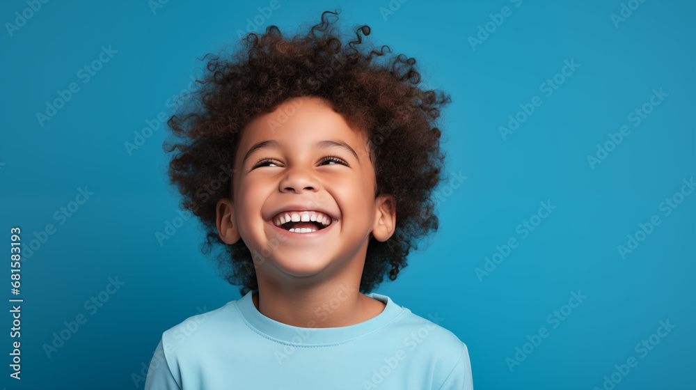 Studio portrait of a diverse boy child smiling on a blue background with space for copy Studio portrait of a diverse boy child smiling on a blue background with space for copy
