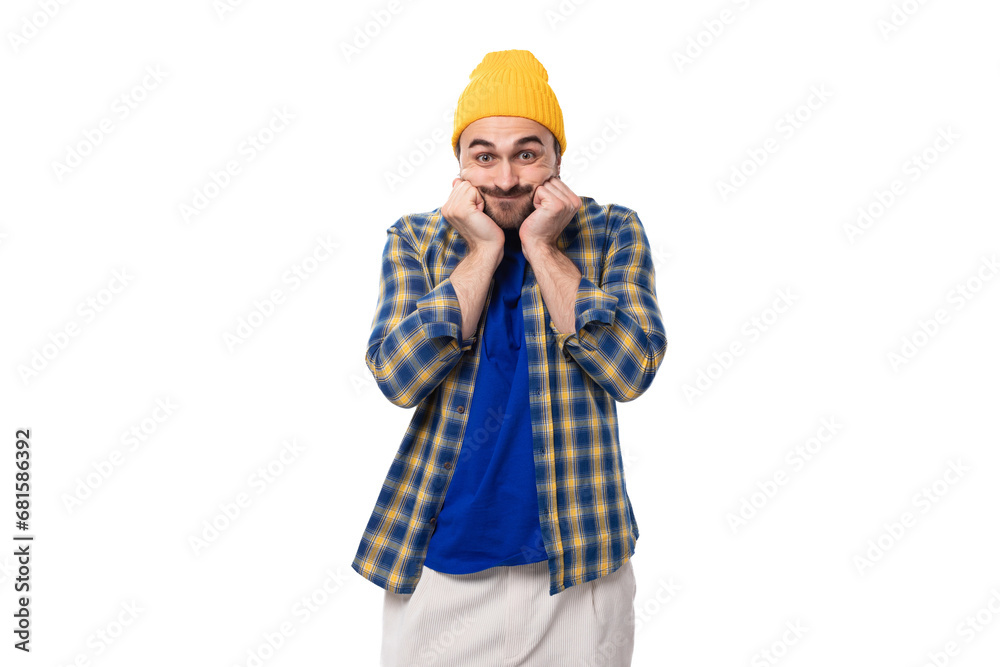 young stylish caucasian brunette handsome guy with a well-groomed beard and mustache in a plaid shirt young stylish caucasian brunette handsome guy with a well-groomed beard and mustache in a plaid shirt