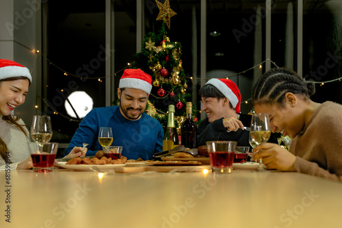 Party of beautiful asian friend female and male celebrating. freind serving pizza on table with snack and drink. happiness friends christmas eve celebration dinner party food and champagne.