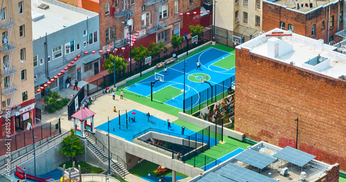 Willie Woo Woo Wong Playground with children and parents on courts surrounded by apartment buildings, San Francisco, CA