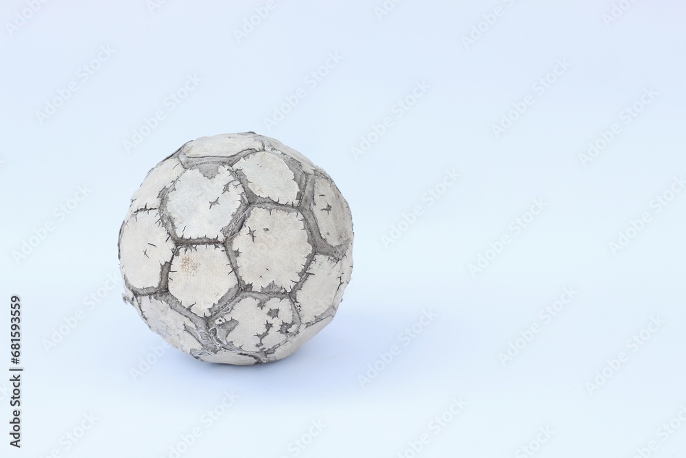Naklejka premium Old used football or soccer ball isolated on white background