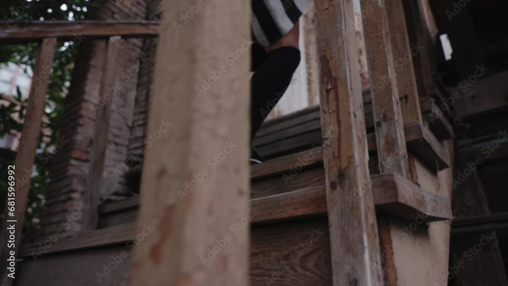A close-up shot of a girl's legs in long dark socks, running up the stairs of an old house. slow motion, daytime, outdoor A close-up shot of a girl's legs in long dark socks, running up the stairs of an old house. slow motion, daytime, outdoor