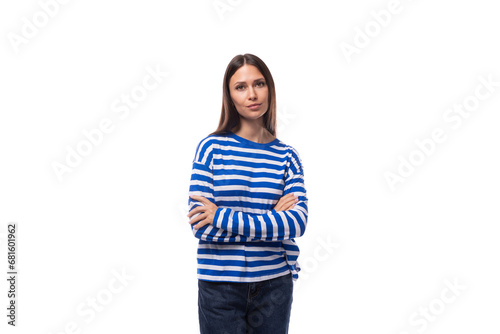 smart young stylish woman with straight hair dressed in a striped sweater