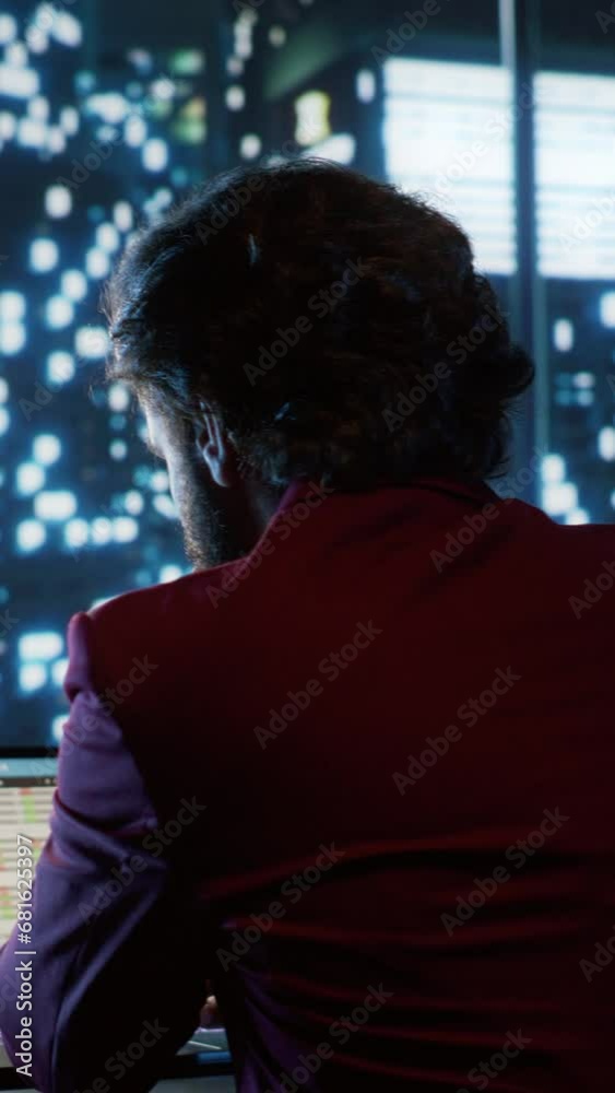 Vertical Video Analyst reviewing authorized financial records and practices for productivity, working at night in sophisticated offices to relieve the administration budget concerns. Stock market Vertical Video Analyst reviewing authorized financial records and practices for productivity, working at night in sophisticated offices to relieve the administration budget concerns. Stock market