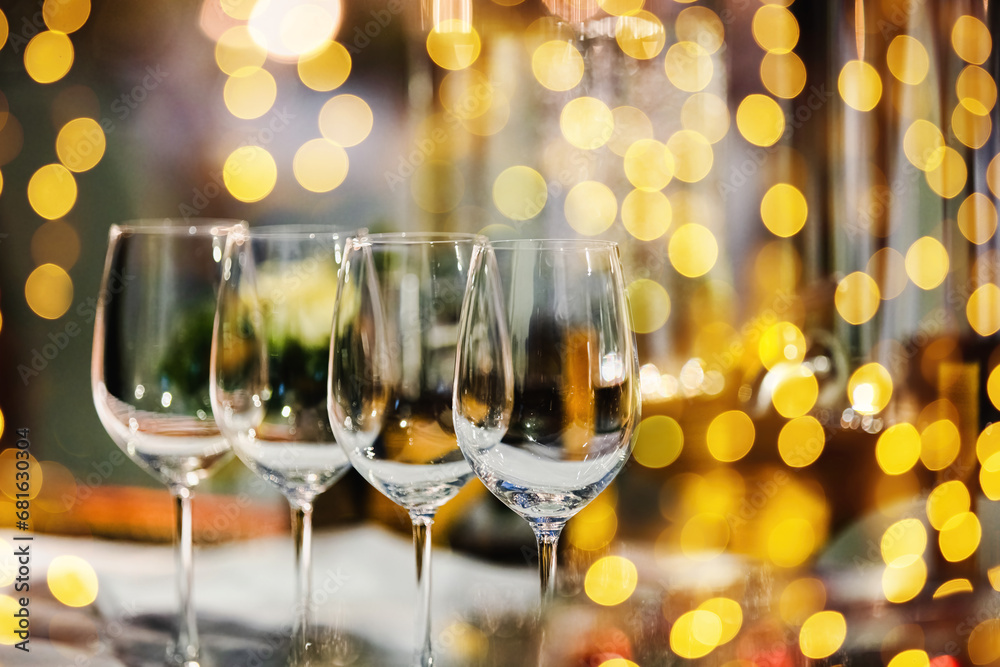 A glass of champagne on table with blur light in restaurant. A glass of champagne on table with blur light in restaurant.
