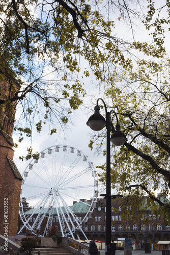 Holiday fun on Advent Christmas market in Szeged Hungary - giant observatio ferris wheel on Dóm tér Szeged Hungary