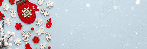 White and red Christmas toys on a blue background, Merry Christmas and Happy New Year banner, top view, copy space photo