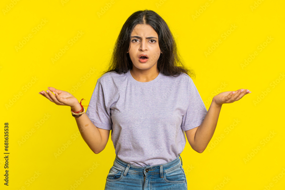 What. Why. Angry Indian woman raising hands in indignant expression, asking reason of failure, demonstrating disbelief irritation by troubles. Arabian young girl isolated on yellow studio background - obrazy, fototapety, plakaty 