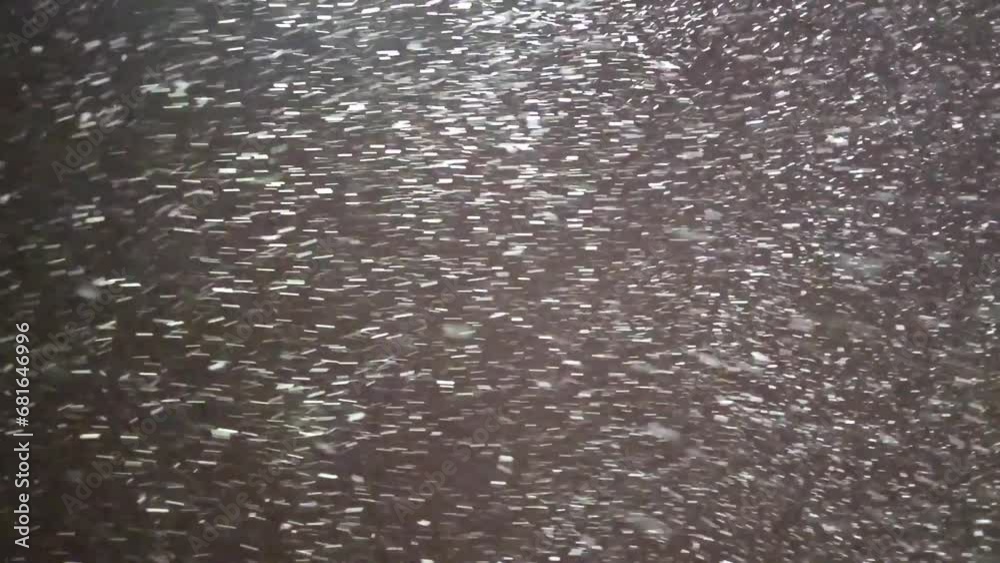 The first snow falls from the sky at night in the light of street lamps The first snow falls from the sky at night in the light of street lamps
