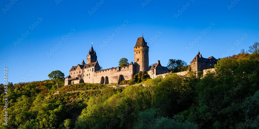 Altena panorama in Sauerland Germany with castle “Burg Altena“, a famous landmark monument in the Lenne Valley and Mediaval Sight with First Youth Hostel of the World on a sunny blue sky spring day.