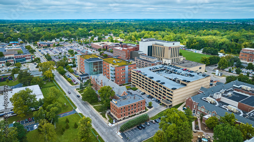 Ball State University, Muncie IN with green rooftop and parking garage in middle of campus aerial photo