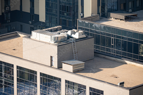 A flat roof with air conditioning and an air vent system at the top.