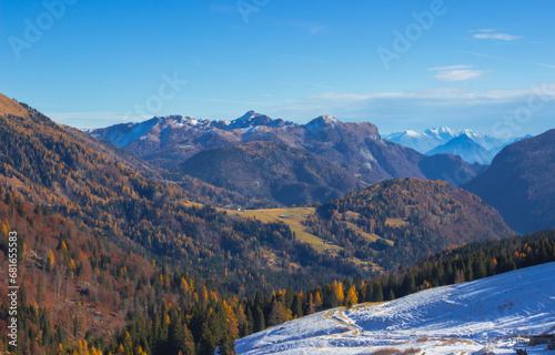 Beautiful late autumn landscape in the Alps. Mountains with some snow and some yellow larches. Breathtaking panorama. Sella di Razzo  Carnic Alps  Italy